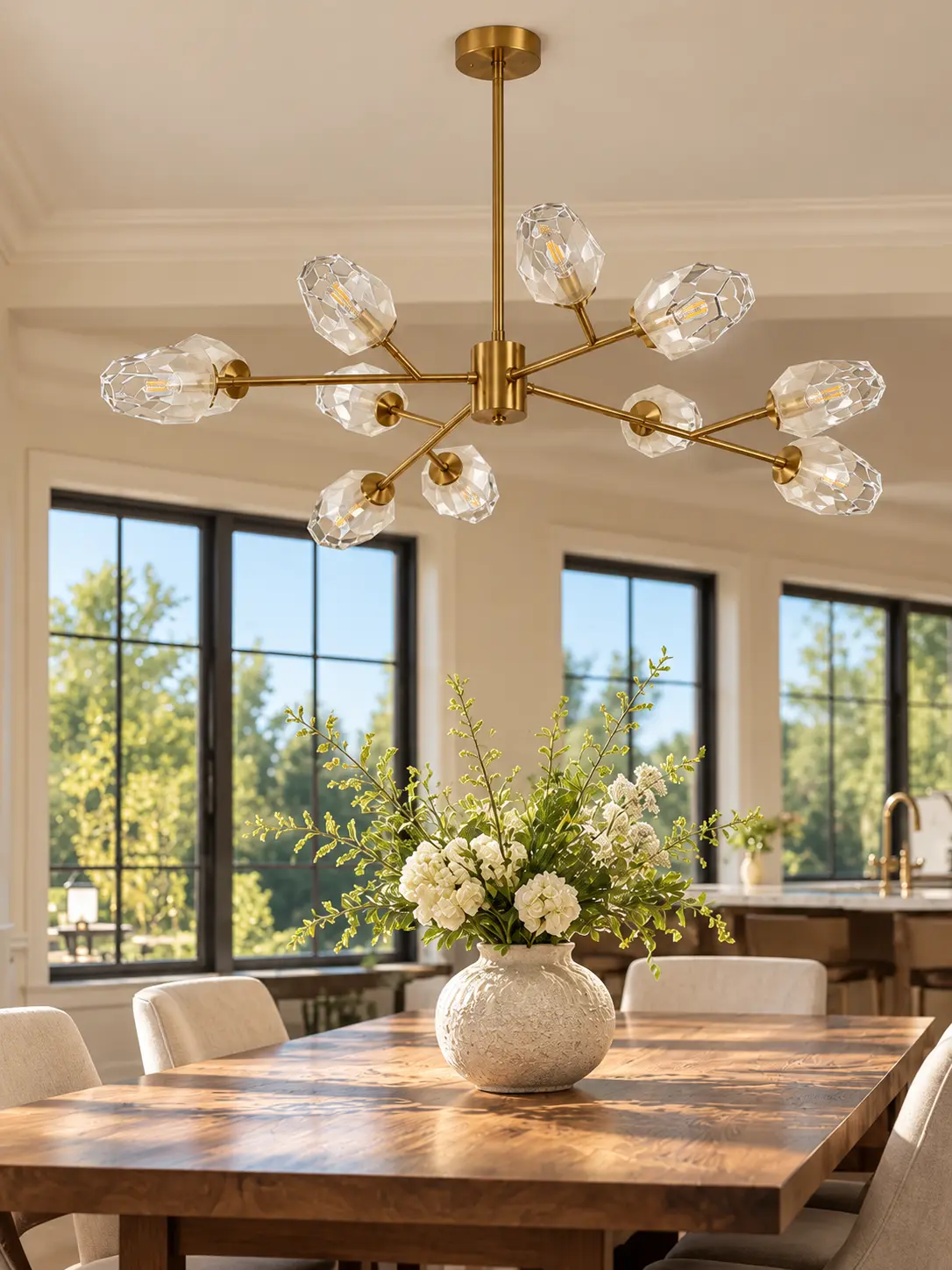 Brushed gold Sputnik chandelier above a wooden dining table in daylight