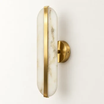Oval alabaster wall sconce with natural white stone shade, vertical brass-finish detail and round gold backplate